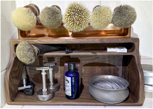 A shelf with shaving brushes and razors